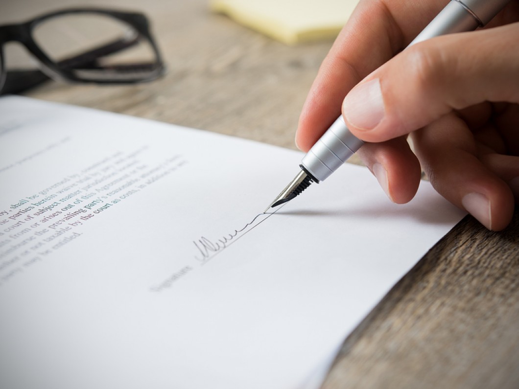 person signing a document