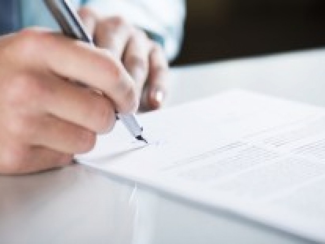 person signing a document